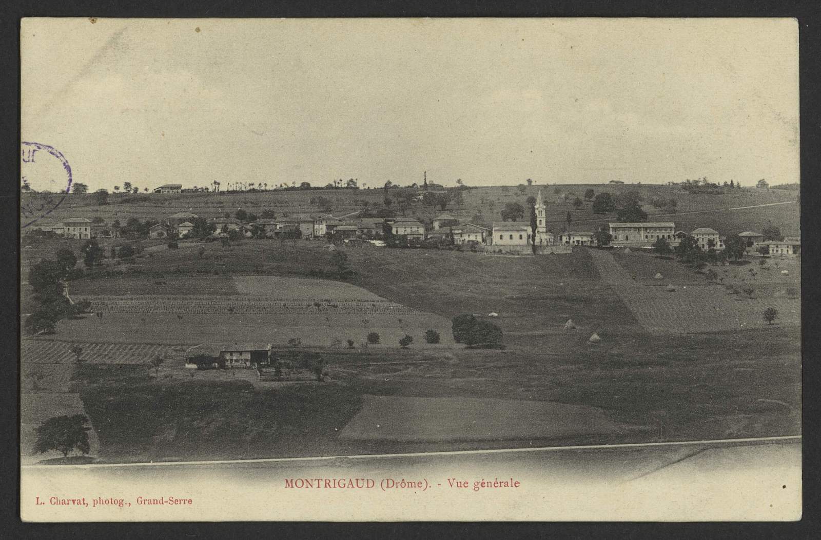 Vue générale de Montrigaud vers 1900, village étiré sur sa croupe au-dessus des champs et des meules